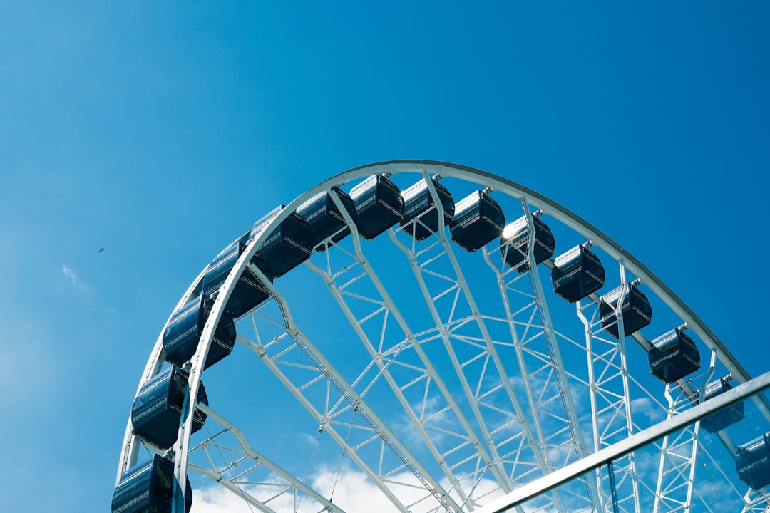 Ferris wheel against a bright blue sky.